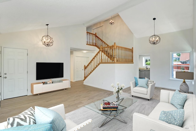 181 Belvedere Ct, Vallejo, CA 94589 - living room featuring stairway, a chandelier, wood finished floors, high vaulted ceiling, and baseboards