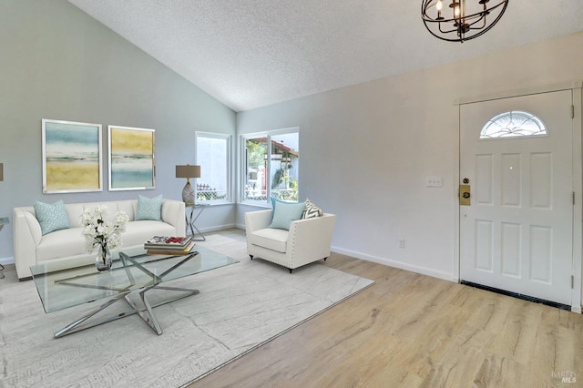 181 Belvedere Ct, Vallejo, CA 94589 - living room with wood finished floors, a chandelier, a textured ceiling, baseboards, and high vaulted ceiling