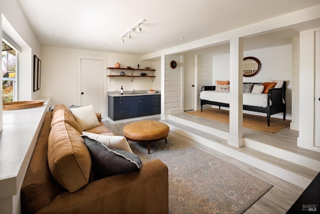 living room with light wood-style flooring and bar area