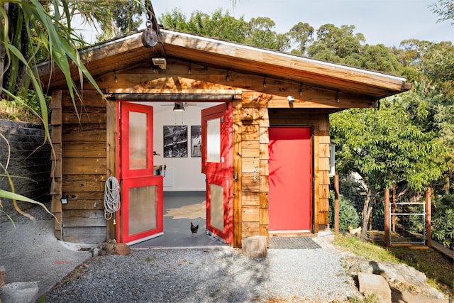 view of outbuilding featuring an outdoor structure and fence