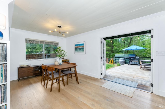 4512 Dry Creek Rd, Napa, CA 94558 - dining space with healthy amount of natural light, a chandelier, light wood-style floors, baseboards, and crown molding