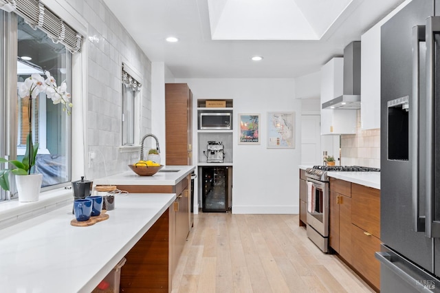 4512 Dry Creek Rd, Napa, CA 94558 - kitchen with appliances with stainless steel finishes, wall chimney exhaust hood, beverage cooler, modern cabinets, and brown cabinetry