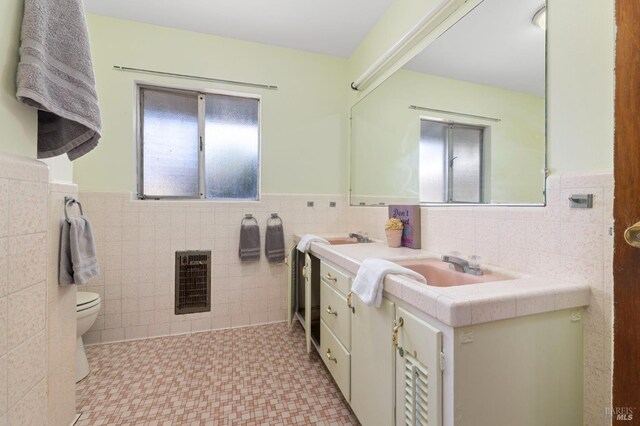 4335 Bodega Ave, Petaluma, CA 95942 - bathroom featuring tile walls, a wainscoted wall, vanity, toilet, and tile patterned floors