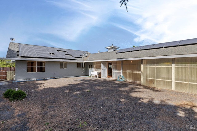 4335 Bodega Ave, Petaluma, CA 95942 - rear view of house with solar panels, fence, and stucco siding