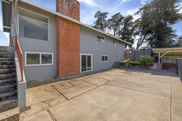 4335 Bodega Ave, Petaluma, CA 95942 - back of property with a chimney, a patio, fence, stucco siding, and stairs