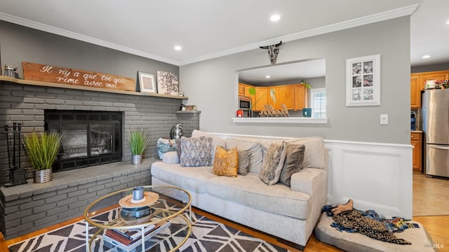 1295 Marian Way, Petaluma, CA 94954 - living room with crown molding, a wainscoted wall, a fireplace, light wood-style flooring, and recessed lighting