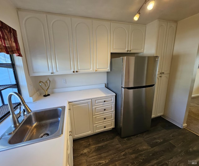 2145 Clearview Cir, Benicia, CA 94510 - kitchen with freestanding refrigerator, a sink, dark wood-style floors, white cabinetry, and light countertops