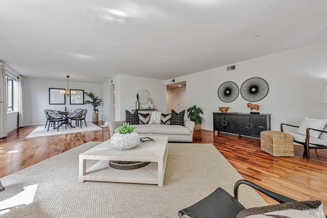 600 Deer Valley Rd Unit 1E, San Rafael, CA 94903 - living room with a chandelier, wood finished floors, and baseboards