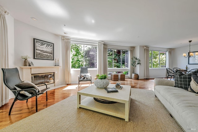 600 Deer Valley Rd Unit 1E, San Rafael, CA 94903 - living area featuring a chandelier, wood finished floors, and a fireplace with flush hearth