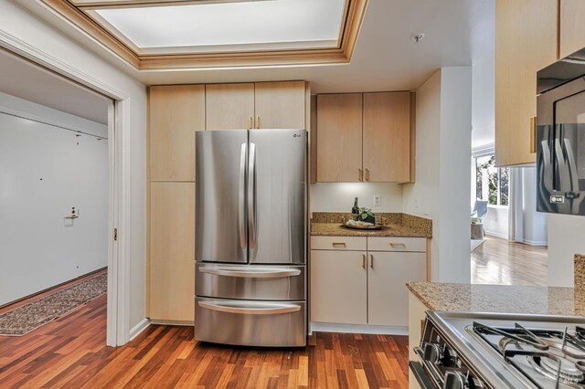 600 Deer Valley Rd Unit 1E, San Rafael, CA 94903 - kitchen featuring appliances with stainless steel finishes, wood finished floors, light stone counters, and a raised ceiling