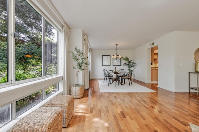 600 Deer Valley Rd Unit 1E, San Rafael, CA 94903 - dining area featuring a chandelier, healthy amount of natural light, light wood-style flooring, and baseboards