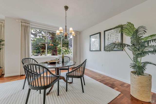 600 Deer Valley Rd Unit 1E, San Rafael, CA 94903 - dining room featuring a chandelier, wood finished floors, and baseboards