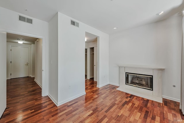 600 Deer Valley Rd Unit 1E, San Rafael, CA 94903 - unfurnished living room with wood finished floors, a premium fireplace, baseboards, and recessed lighting