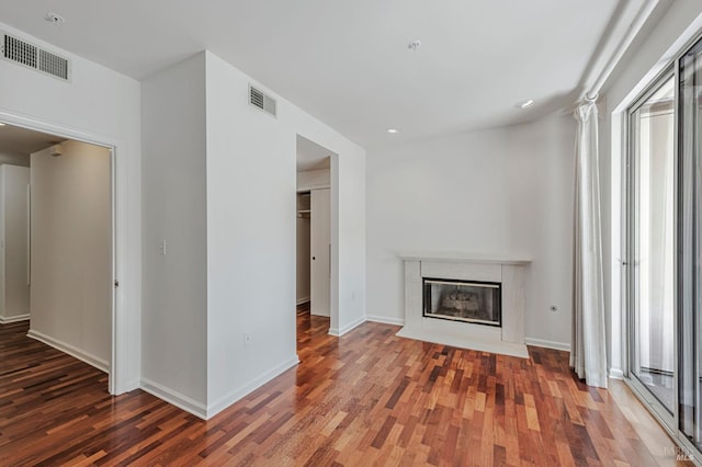 600 Deer Valley Rd Unit 1E, San Rafael, CA 94903 - unfurnished living room featuring wood finished floors, a fireplace, baseboards, healthy amount of natural light, and recessed lighting