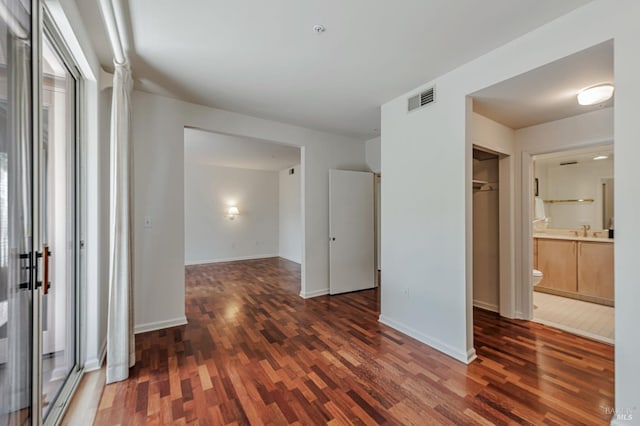 600 Deer Valley Rd Unit 1E, San Rafael, CA 94903 - unfurnished bedroom with wood finished floors, baseboards, ensuite bath, and a sink