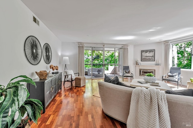 600 Deer Valley Rd Unit 1E, San Rafael, CA 94903 - living room with a glass covered fireplace and wood finished floors