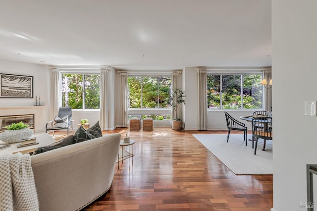 600 Deer Valley Rd Unit 1E, San Rafael, CA 94903 - living area featuring wood finished floors, a glass covered fireplace, and baseboards