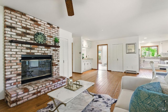 4620 Morris Ct, Santa Rosa, CA 95405 - living area with baseboard heating, light wood-type flooring, a ceiling fan, a brick fireplace, and recessed lighting