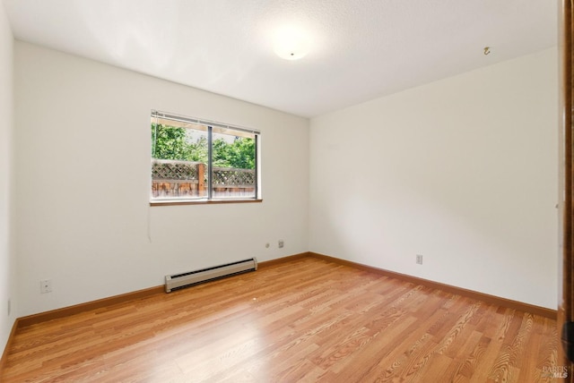 4620 Morris Ct, Santa Rosa, CA 95405 - empty room with a baseboard radiator, light wood finished floors, and baseboards