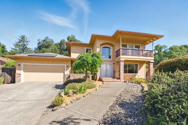 4620 Morris Ct, Santa Rosa, CA 95405 - view of front facade with a balcony, solar panels, concrete driveway, a garage, and brick siding
