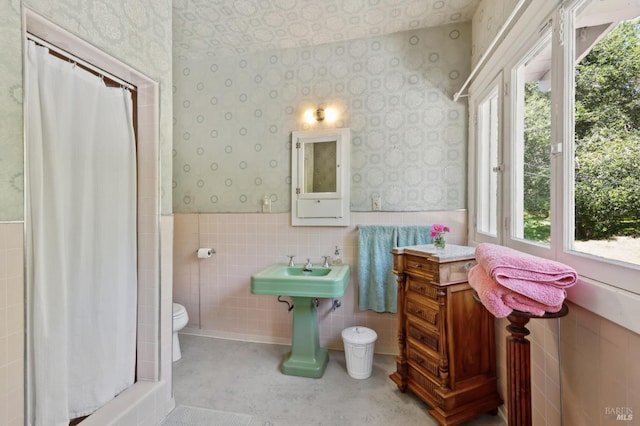 4100 Petrified Forest Rd, Santa Rosa, CA 94515 - bathroom featuring wallpapered walls, tile walls, a wainscoted wall, toilet, and curtained shower