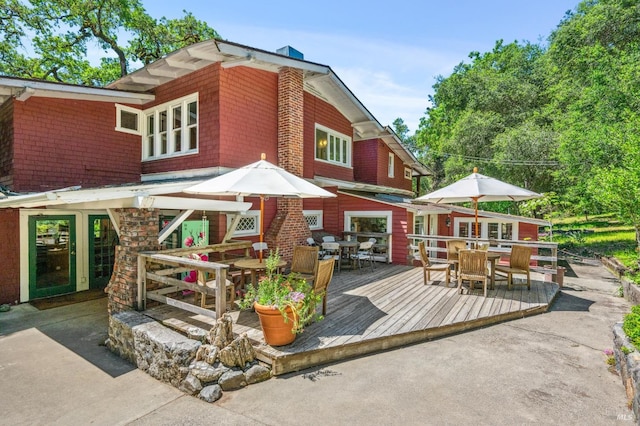 4100 Petrified Forest Rd, Santa Rosa, CA 94515 - back of house featuring outdoor dining space, a wooden deck, and a chimney