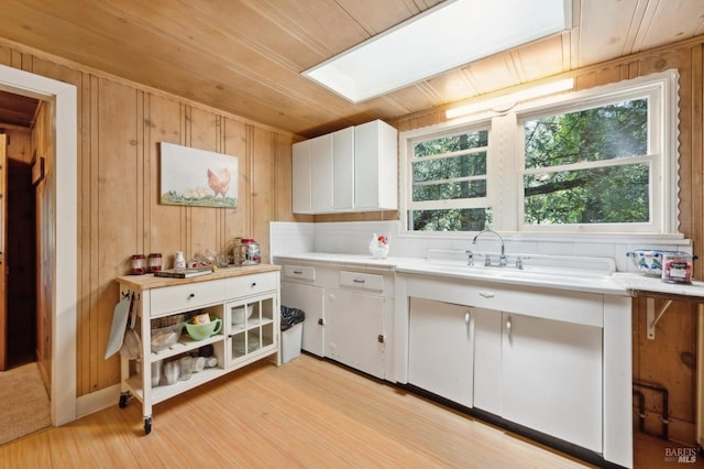 4100 Petrified Forest Rd, Santa Rosa, CA 94515 - kitchen with white cabinetry, light wood-type flooring, a skylight, wooden walls, and wooden ceiling