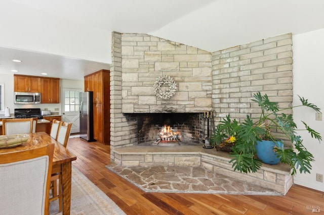 4100 Petrified Forest Rd, Santa Rosa, CA 94515 - living area featuring wood finished floors, vaulted ceiling, and a fireplace
