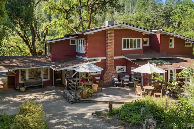 4100 Petrified Forest Rd, Santa Rosa, CA 94515 - view of front of house featuring a wooden deck, outdoor dining space, and central AC