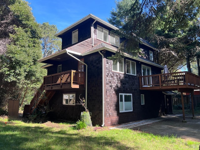 32851 Leofs Ln, Fort Bragg, CA 95437 - back of property with a wooden deck, stairway, and a patio
