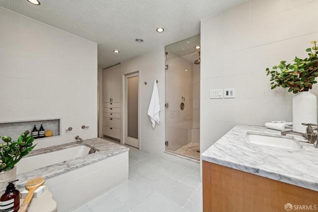 2111 Vallejo St, San Francisco, CA 94123 - full bath with a shower stall, a garden tub, recessed lighting, vanity, and tile patterned flooring