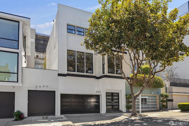 2111 Vallejo St, San Francisco, CA 94123 - modern home with a garage, concrete driveway, and stucco siding