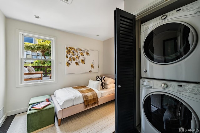 2111 Vallejo St, San Francisco, CA 94123 - laundry area featuring stacked washer / dryer, wood finished floors, and baseboards