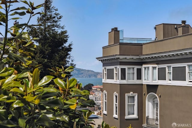 2111 Vallejo St, San Francisco, CA 94123 - view of property exterior featuring a chimney, stucco siding, and a mountain view