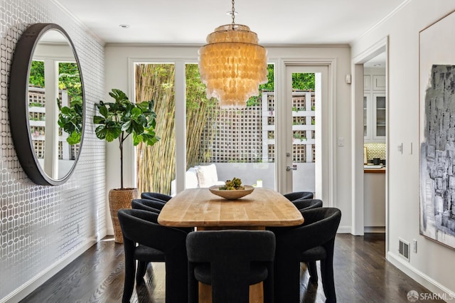 2111 Vallejo St, San Francisco, CA 94123 - dining room featuring dark wood finished floors, a chandelier, ornamental molding, and baseboards