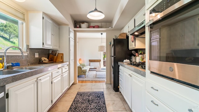 9 Endeavor Cv, Corte Madera, CA 94925 - kitchen with a sink, stainless steel oven, tasteful backsplash, under cabinet range hood, and white cabinetry