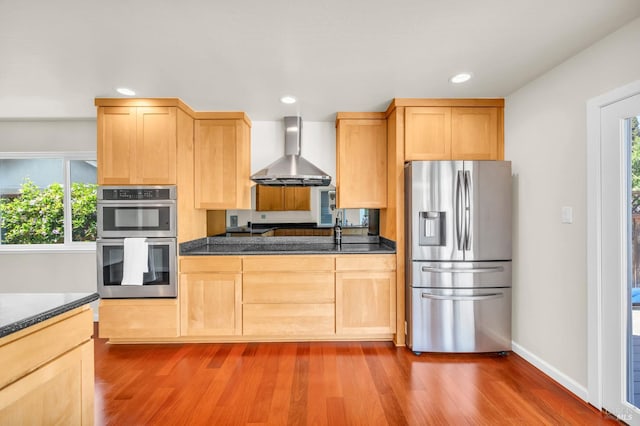 3730 Ruston Ln, Napa, CA 94558 - kitchen featuring appliances with stainless steel finishes, wall chimney range hood, light brown cabinetry, dark countertops, and dark wood finished floors