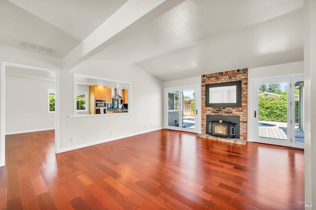 3730 Ruston Ln, Napa, CA 94558 - unfurnished living room featuring wood finished floors, vaulted ceiling, baseboards, and a wood stove