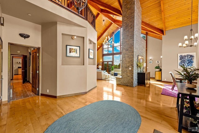 303 Mctavish Ct Unit A, Fairfield, CA 94534 - entryway with a chandelier, high vaulted ceiling, a wooden ceiling with exposed beams, decorative columns, and wood-type flooring