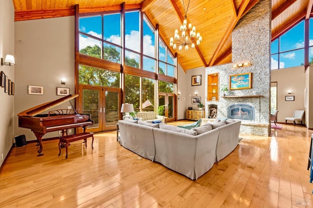 303 Mctavish Ct Unit A, Fairfield, CA 94534 - living room featuring high vaulted ceiling, a wood ceiling with exposed beams, a stone fireplace, light wood-style flooring, and a chandelier