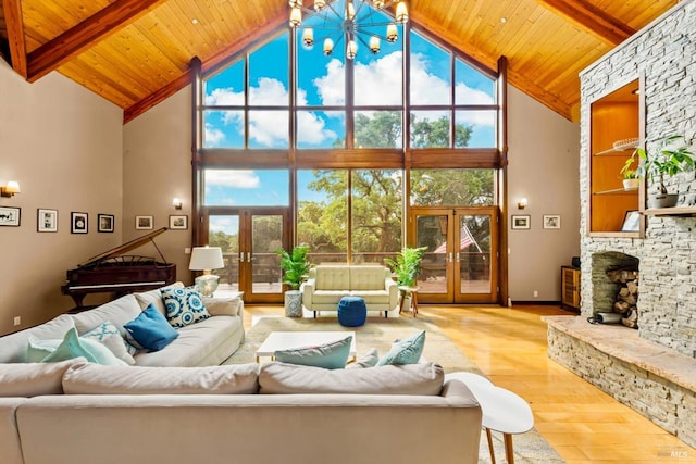 303 Mctavish Ct Unit A, Fairfield, CA 94534 - living area featuring french doors, high vaulted ceiling, hardwood / wood-style flooring, a wood ceiling with exposed beams, and a stone fireplace