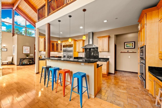 303 Mctavish Ct Unit A, Fairfield, CA 94534 - kitchen with wall chimney range hood, built in appliances, dark countertops, a kitchen breakfast bar, and a wooden ceiling with exposed beams