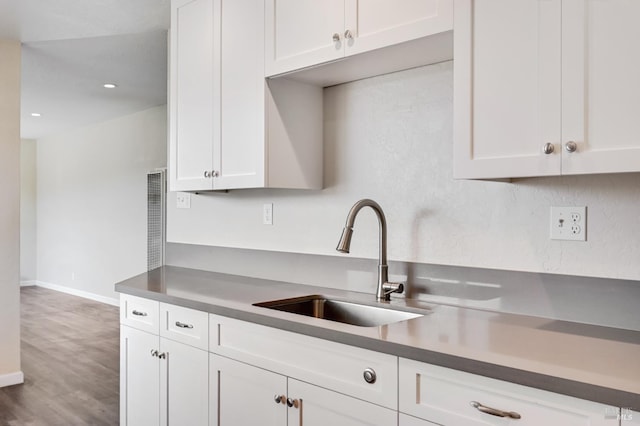 1313 Mcneil Ave, Petaluma, CA 94954 - kitchen with a sink, white cabinets, wood finished floors, baseboards, and recessed lighting