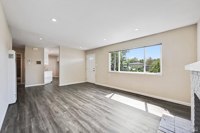 1313 Mcneil Ave, Petaluma, CA 94954 - unfurnished living room featuring baseboards, a fireplace, wood finished floors, and recessed lighting
