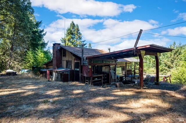 0 Low Gap Rd, Ukiah, CA 95482 - rear view of house featuring a chimney and a carport