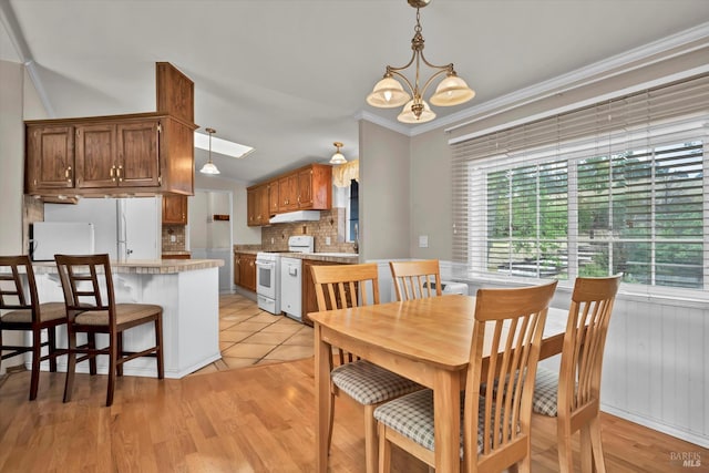 4538 Hill Rd, Lakeport, CA 95453 - dining space featuring a chandelier, ornamental molding, and light wood-type flooring