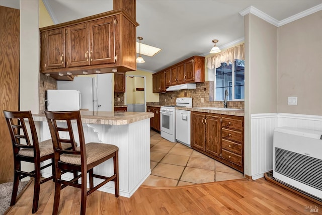 4538 Hill Rd, Lakeport, CA 95453 - kitchen featuring white appliances, under cabinet range hood, a peninsula, heating unit, and a sink