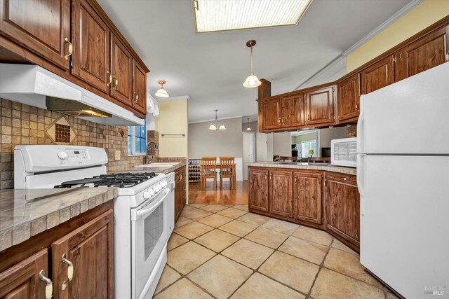 4538 Hill Rd, Lakeport, CA 95453 - kitchen with white appliances, under cabinet range hood, a sink, ornamental molding, and tasteful backsplash