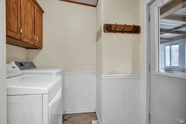 4538 Hill Rd, Lakeport, CA 95453 - laundry room with washer and dryer, a wainscoted wall, cabinet space, light tile patterned floors, and wooden walls