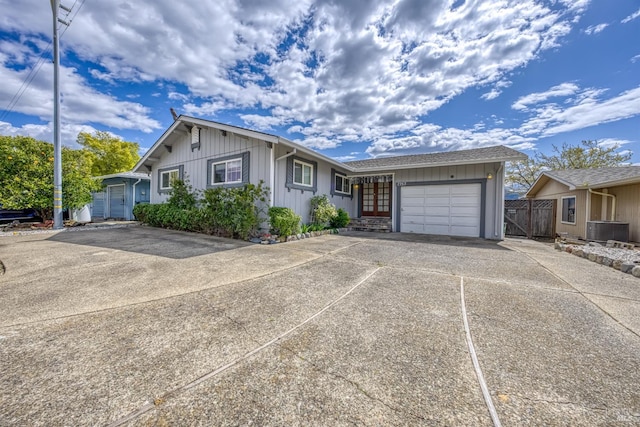 7753 N Cora Dr, Lucerne, CA 95458 - ranch-style home with a garage, driveway, board and batten siding, central AC unit, and fence